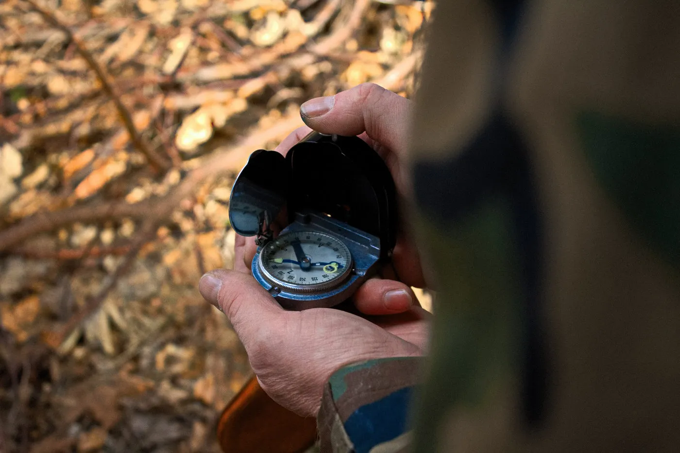 Hands holding a compass