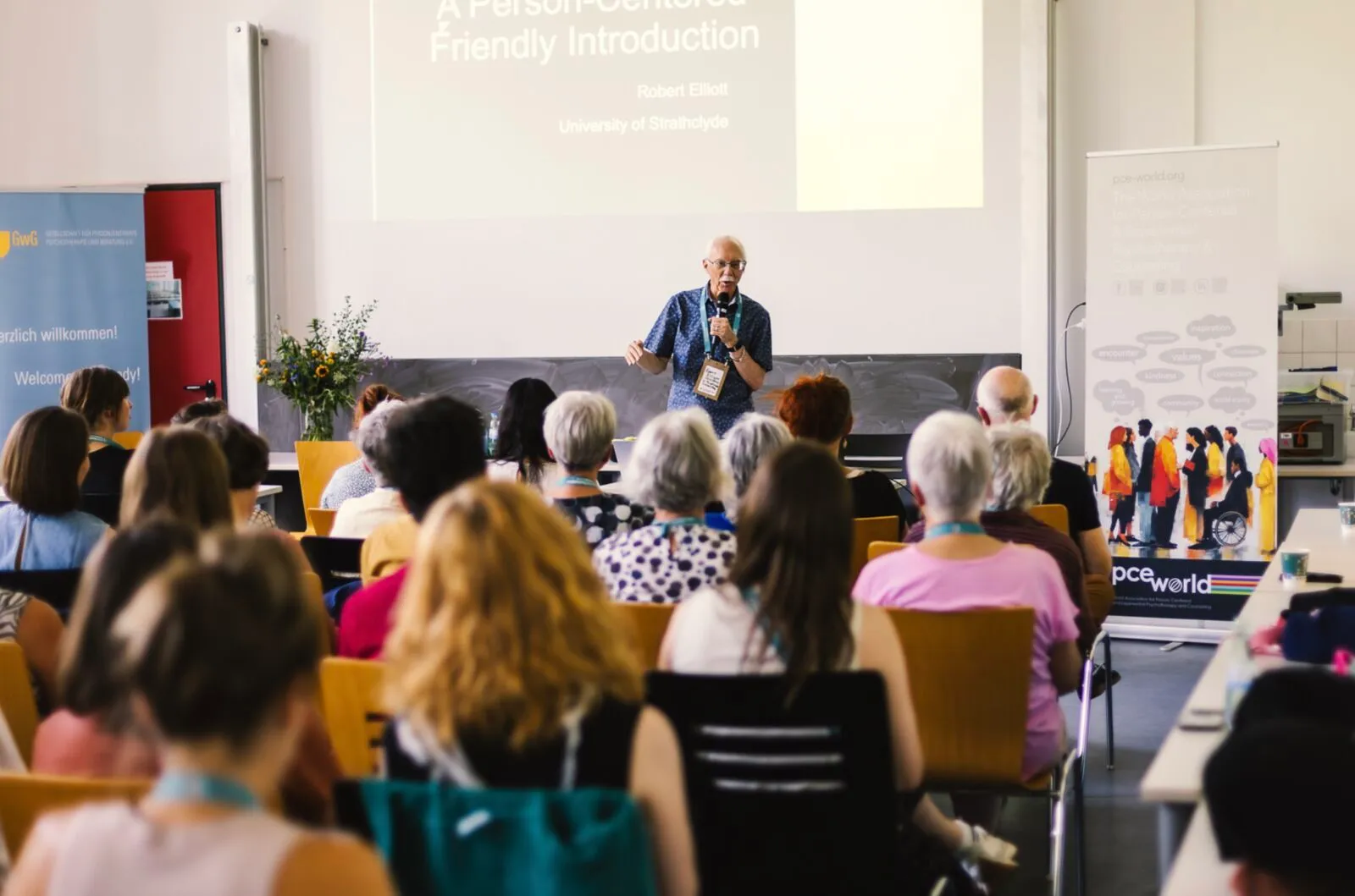 A speaker presenting to an audience in a lecture hall