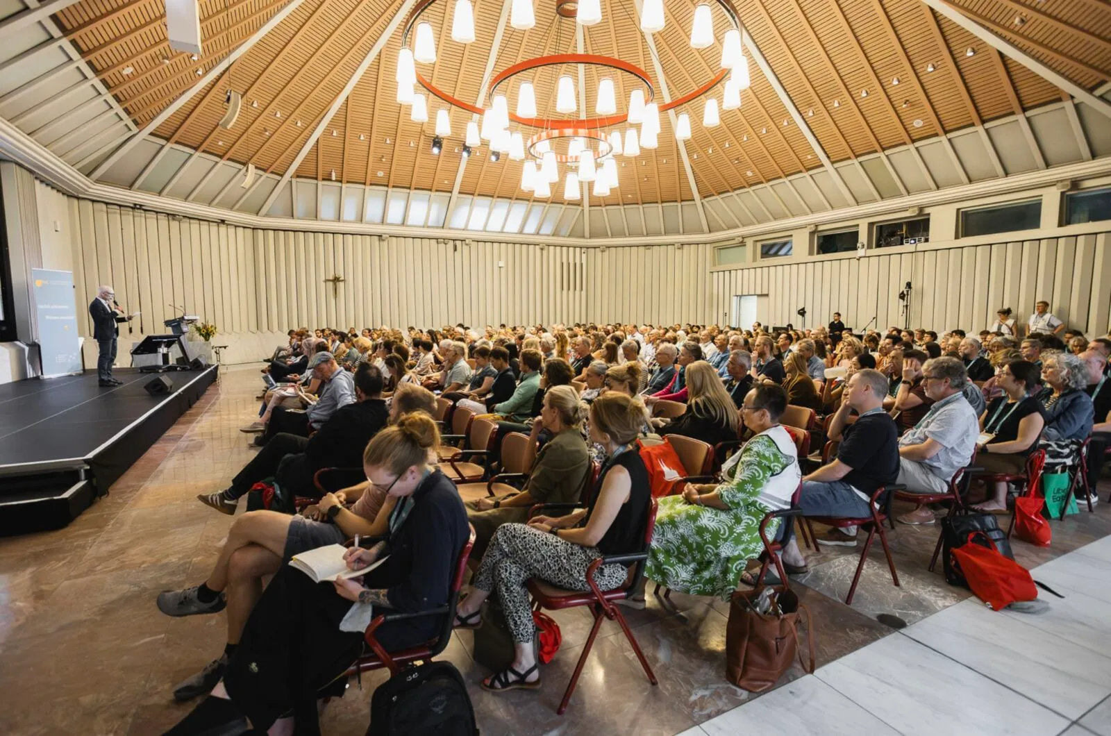 Aerial view of a large group of conference delegates gathered in a courtyard