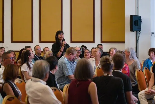 Audience at the isEFT conference as a speaker addresses the room