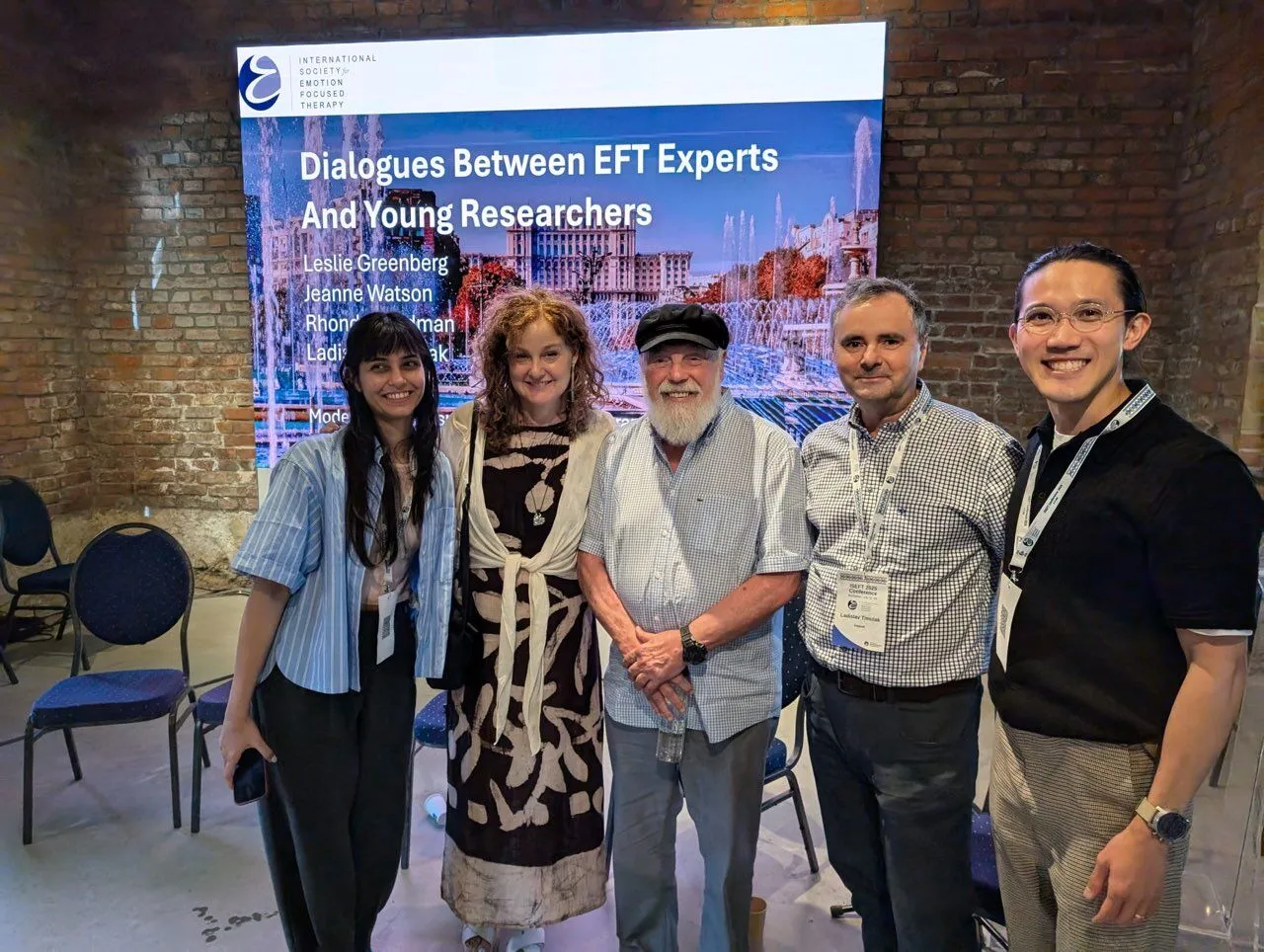 Five attendees in front of a banner for the session Dialogues Between EFT Experts and Young Researchers